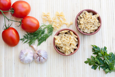 Pasta with fresh vegetables and herbsの写真素材