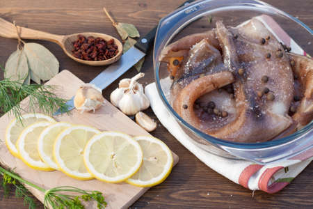 Fresh squid carcass in a glass pot with herbs and sliced lemonの写真素材