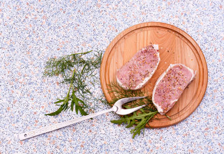 Fresh Raw Steak Meat with spaces and herbs on wooden boardの写真素材