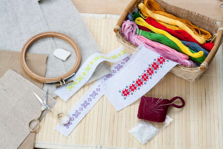 Sewing and ambroidery craft kit, embroidery thread in basket and other tools, selective focusの写真素材