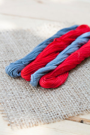 Mouline, embroidery thread on a napkin of burlap, selective focus