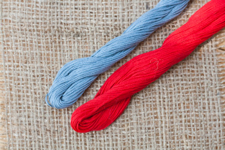 Mouline, embroidery thread on a napkin of burlap, selective focus