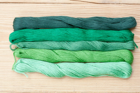 Mouline, embroidery thread on light wooden table, selective focus