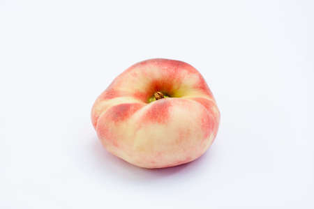 Ripe flat Chinese peaches on the white isolatd backgroundの写真素材