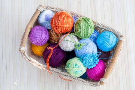 Colorful clews and crochet hook on wooden backgroundの写真素材