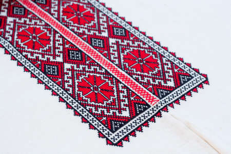 Shirt with national Ukrainian embroidered red and black colors, selective focusの写真素材