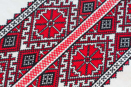 Shirt with national Ukrainian embroidered red and black colors, selective focusの写真素材