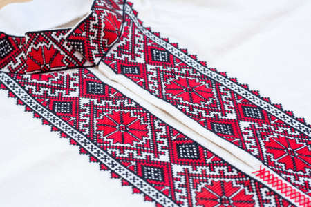 Shirt with national Ukrainian embroidered red and black colors, selective focusの写真素材