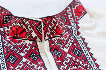 Shirt with national Ukrainian embroidered red and black colors, selective focusの写真素材