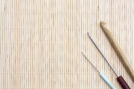 Crochet hooks on light makisu close-up, selective focusの写真素材