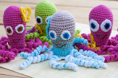 Crocheted woven with colored wool toy octopus close-up, selective focus