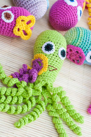 Crocheted woven with colored wool toy octopus close-up, selective focusの写真素材