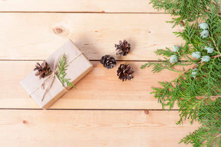 Christmas Gift, nuts, cones and green arborvitae branch on a wooden tableの写真素材
