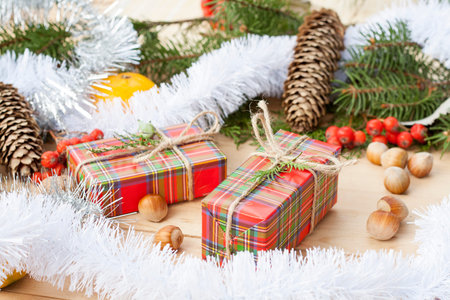 Christmas gift box with New Year's and Christmas decoration midst fruits and tinsel.