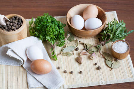 Fresh eggs with champignon mushrooms, vegetables and spicesの写真素材