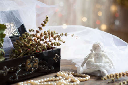 Angel and Pearls necklace in black casket on colorful background bokehの写真素材
