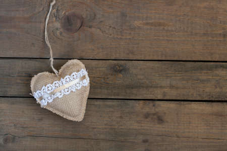 Handmade Valentines day heart on wooden table. Top view with copy spaceの写真素材