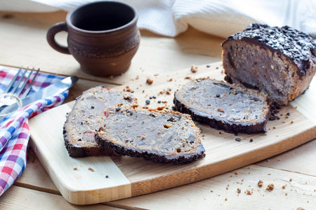 Stollen traditional German Christmas yeast cake with raisins served with a cup of coffee decorated...