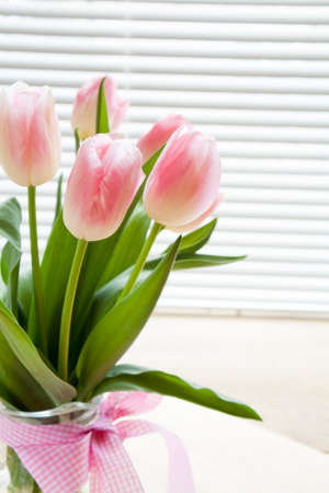 Beautiful bouquet of pink tulips on backlight backgroundの写真素材