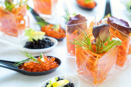 Beautifully decorated catering banquet table with different food salad, caviar on corporate...