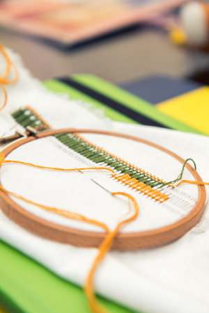 Work in progress. Ukrainian embroidery on the linen fabric and thread embroidery on a table,...