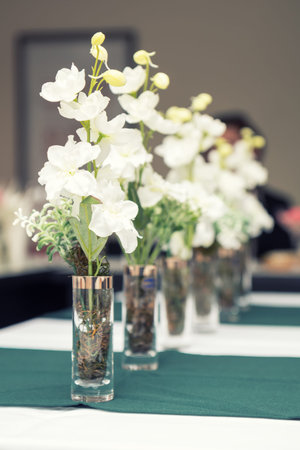 Close up picture of wine glasses with flower in restaurant. Serving table prepared for event party...