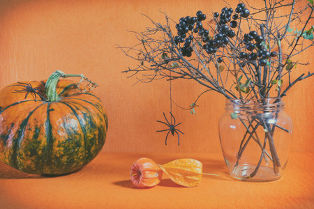 Halloween home decorations on orange background. Still life. Shallow depth of field. Toned.