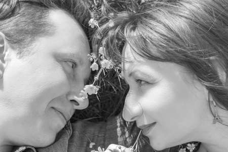 Affectionate young couple looking at each other in park. Love story. Black and white.の写真素材