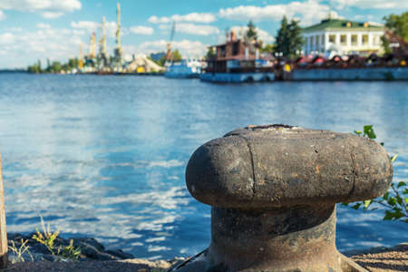 Container cranes in Dnieper river harbor. Loading and unloading cranes in the river port. The river port accepts and ships the cargo across the water.の写真素材