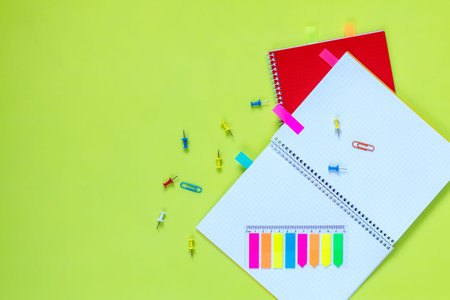 Beautiful office stationery flat lay with ruled red and yellow notebooks, stationery and office...
