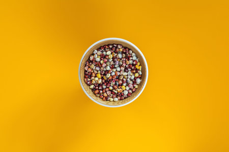Cheerful and Colorful dried Indian Corn on yellow surface as decoration for Thanksgiving Table, Halloween, and the Fall Season.の写真素材