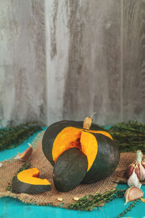 Green Pumpkin, ingredients for tasty vegetarian cooking on light wooden surface, food art backgroundの写真素材