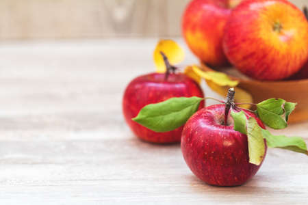 Autumn harvest red apples fruits on a light gray wooden table background. Copy space. Natural remedy. Shallow depth of the field.の写真素材