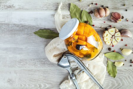Marinated preserving jars. Homemade orange cut pumpkin pickles with red hot chili peppers, fresh...