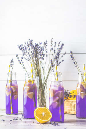Fresh lavender violet cocktail with lemon and ice, drink bottles glass on a  light old rustic style, selective focus, shallow depth of the field.の写真素材