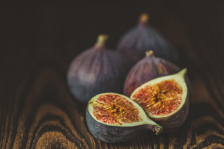 Ripe Fig Fruits on old wooden background. Paleo diet, still life with copy space. Shallow depth of...