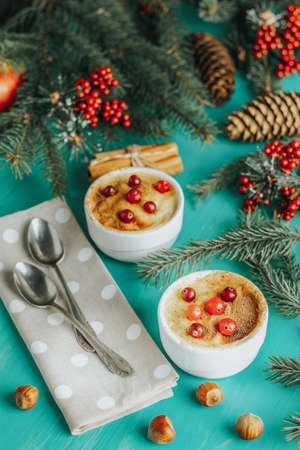Christmas and New Year composition with sweet delicious apples dessert, spruce branches, cutlery on blue turquoise wooden table surface, copy spice, Holidays background, Christmas table place setting.の写真素材