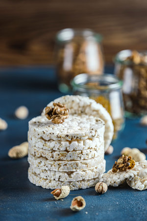 Stack of rice cakes. American puffed rice cakes. Healthy snacks with ears of wheat on classic blue...