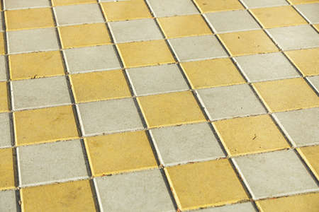 Pavement. Sidewalk tile background. Pavement tile. Top view. Closeup. Footpath. Bright tone two colors.の写真素材