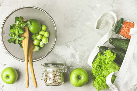 Zero waste concept. Eco-friendly shopping, flat lay. Fresh organic green vegetables and fruits on gray background. Spring diet, healthy raw vegetarian, vegan concept, alkaline clean eatingの写真素材
