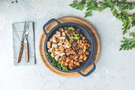 Healthy food. Pan of baking chicken meat, fried sweet potato and brussels sprouts. Top view, light gray concrete surface, flat lay.の写真素材