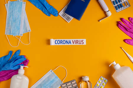 Coronavirus new lifestyle concept. Passports, airplane tickets, sanitizer, thermometer and medical mask flat layの写真素材