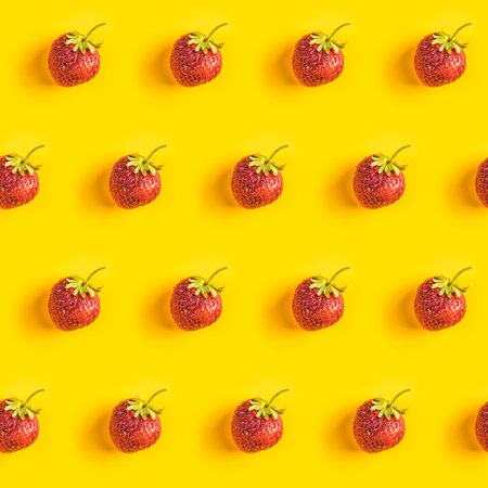 Strawberry seamless pattern, strawberries on yellow colored background, top view, creative...