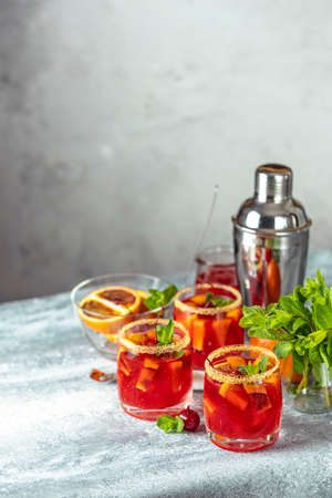 Milano alcoholic cocktail with red bitter, dry white wine, soda, red orange and ice. Light gray background, bar tools, selective focus.の写真素材