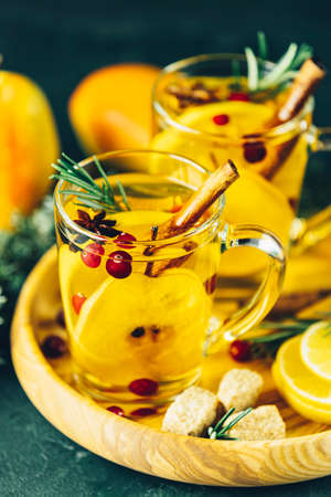 Two glass cup of festive winter drinks, pear cider spice cocktail. Hot drink cocktail for Christmas, winter or autumn holidaysの写真素材