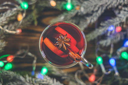 Christmas hot mulled wine in a glass with spices and citrus fruit. Mulled wine with cinnamon, anise and orange. Top view and copy space.の写真素材
