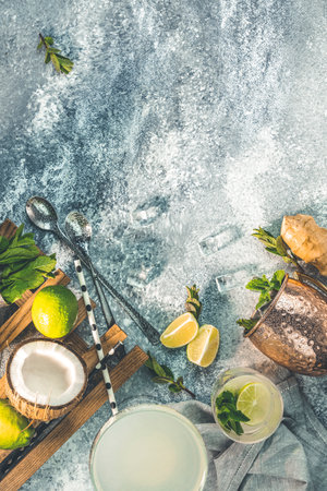 Margarita, Moscow mule and Mojito alcoholic cocktails with ingredients and bartender tools on ultimate gray table surface. Top view, copy space for you text.の写真素材