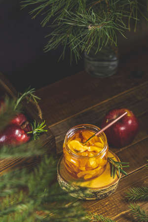 Apple jam or marmalade in jar on dark wooden table surface. Organic healthy vegetarian food, concept of holiday.の写真素材