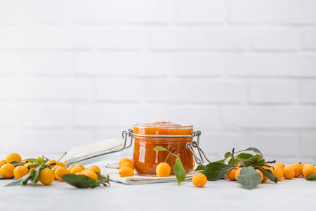 Homemade DIY natural canned yellow cherry plum sauce chutney with chilli or tkemali in glass jar...