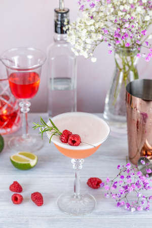 Clover Club Cocktail, a sour drink with Gin, raspberries, and egg white foam on light concrete surface. All day cocktail. Was chartered in 1882.の写真素材